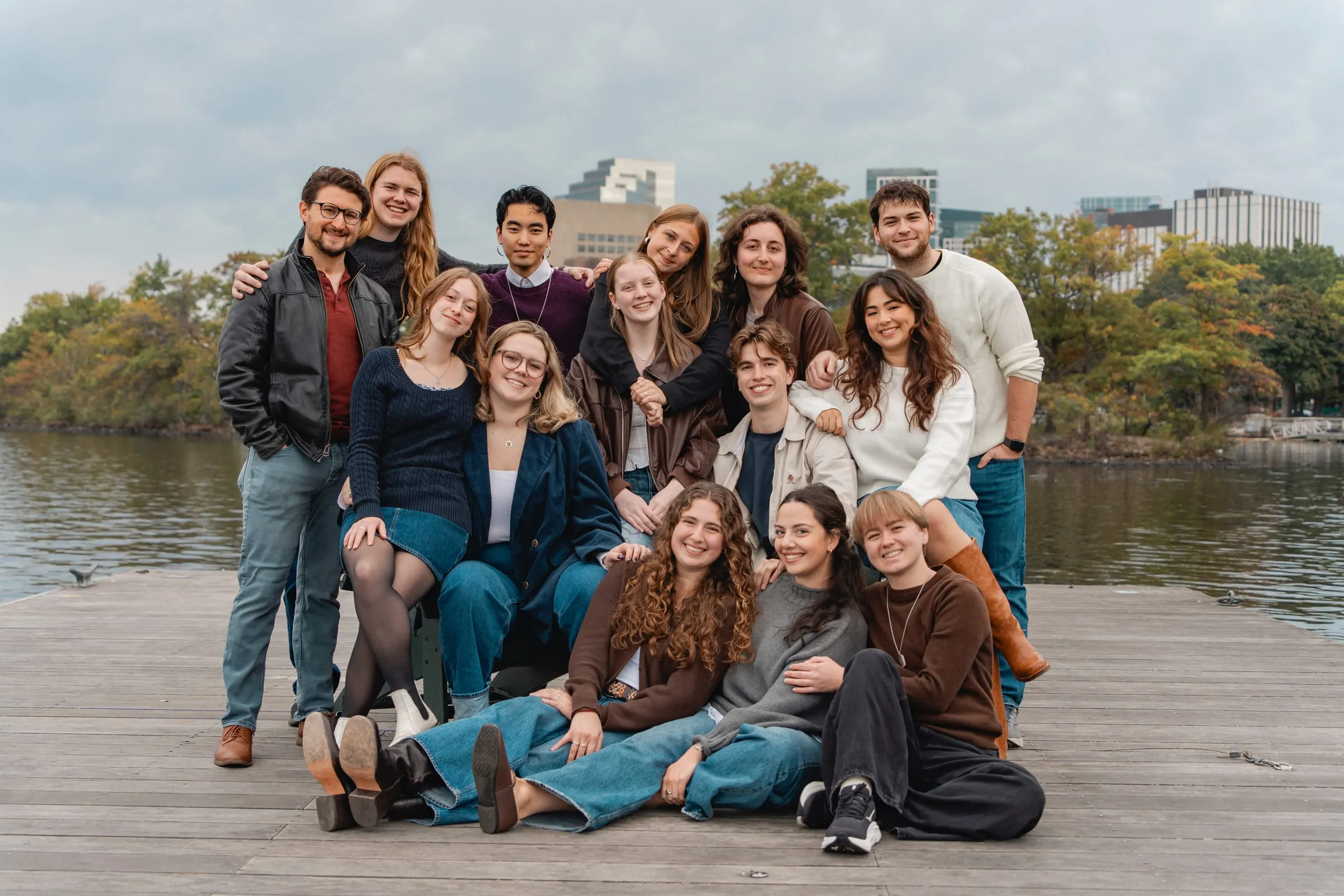 The NU Madrigal Singers posing on a dock by the Charles River